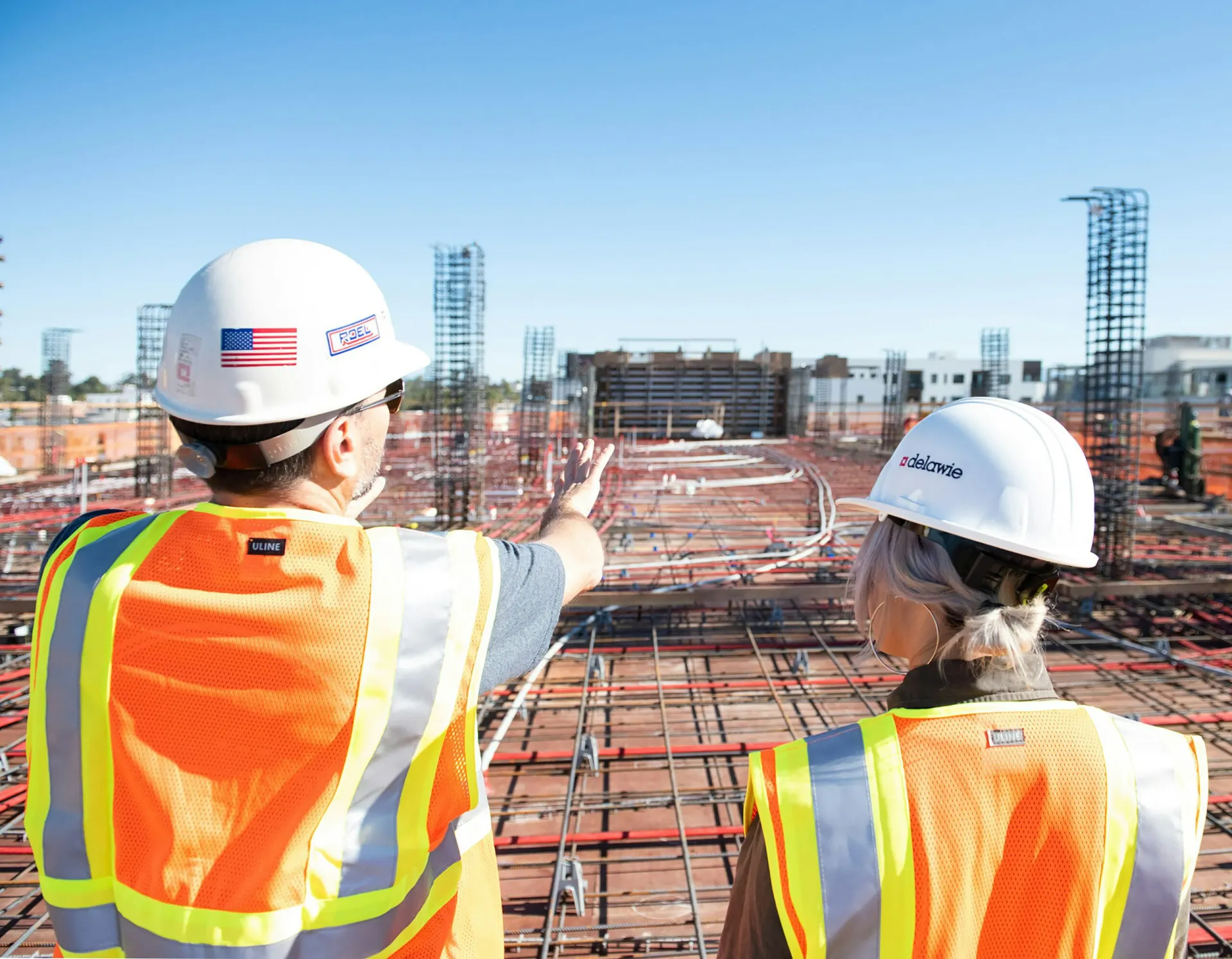 two construction workers looking at a job